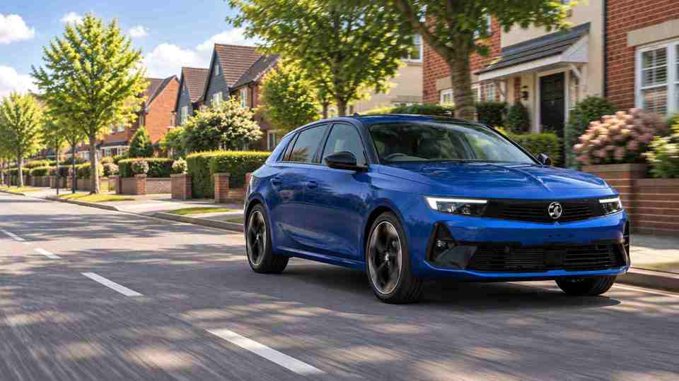 Blue Vauxhall Astra driving through a nice neighbourhood with nice houses