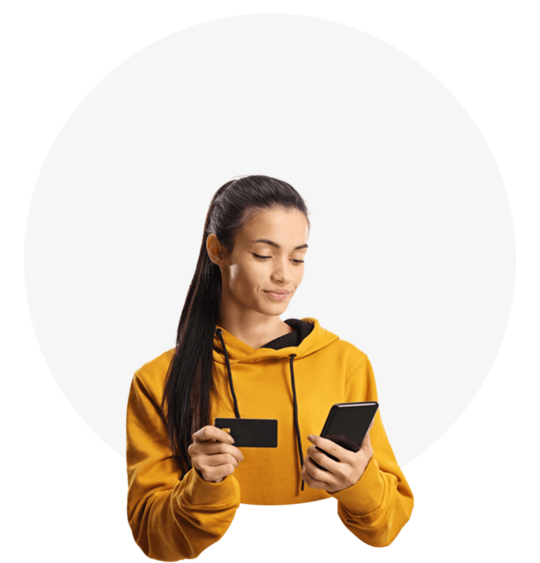 woman in yellow hoodie holding card