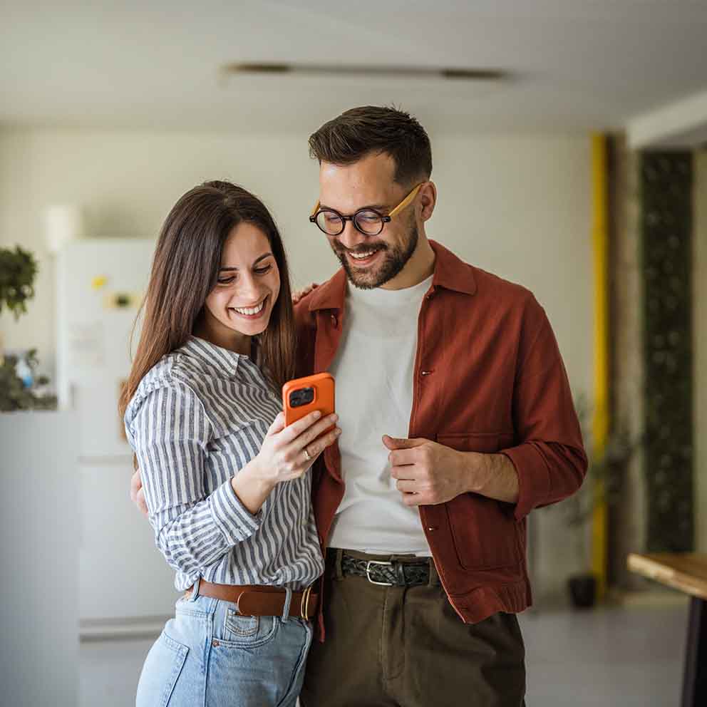 happy couple looking at phone
