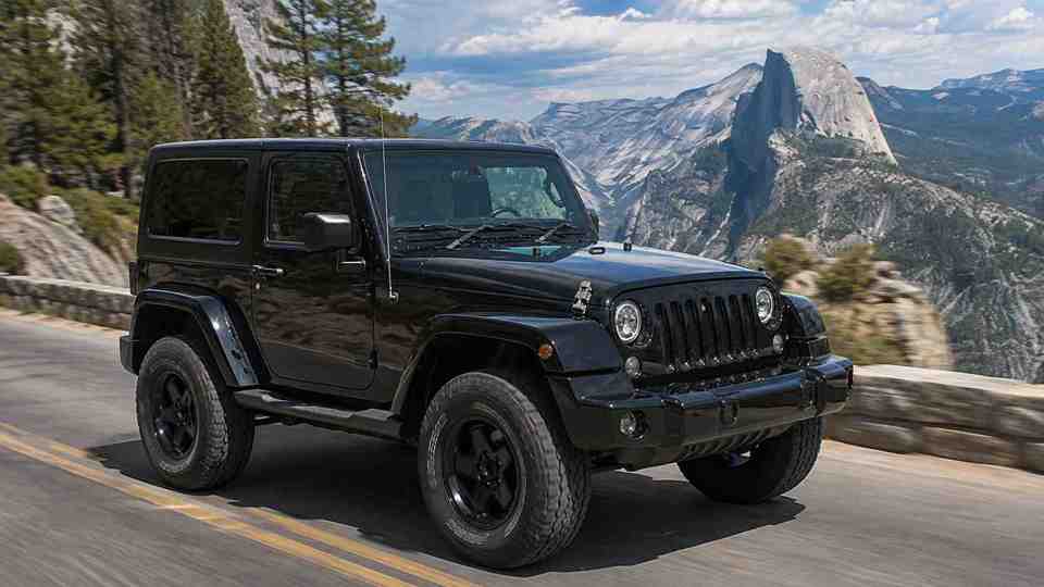 Black Jeep Wrangler driving along mountain roads