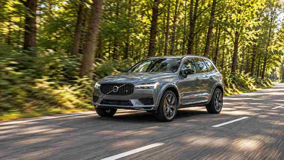 Grey Volvo XC60 driving through a forrest