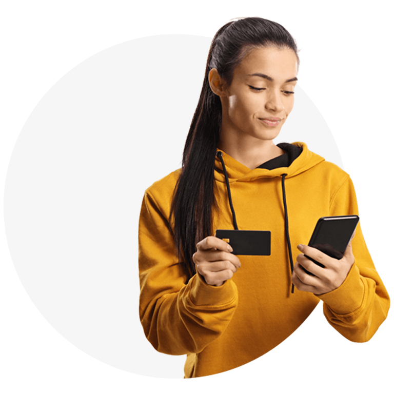 woman in yellow hoodie holding card