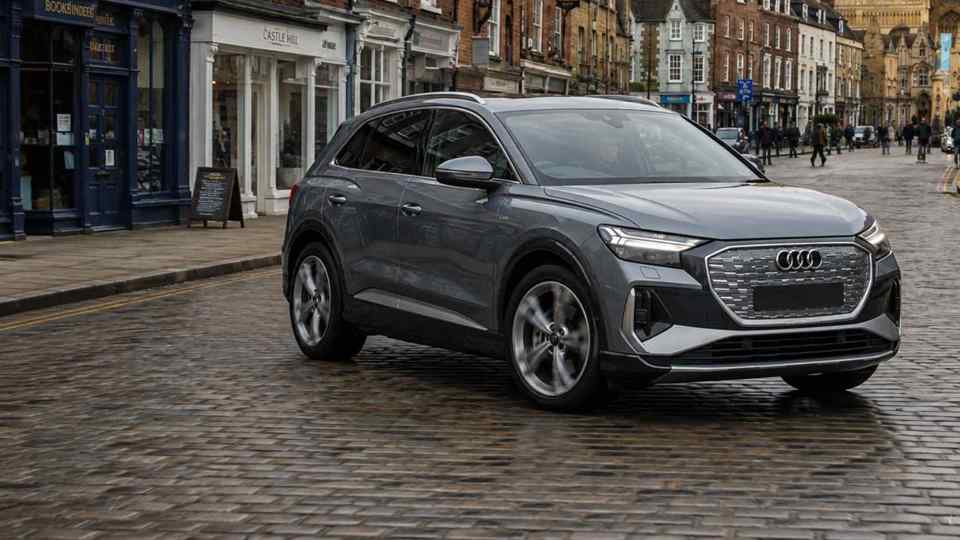 Grey Audi Q5 parked on cobble road next to shops