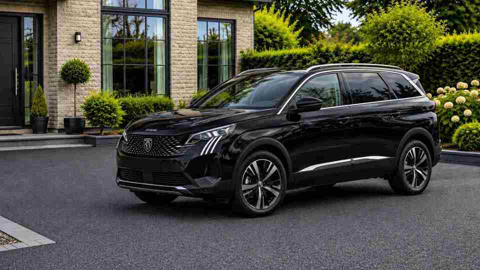 Black Peugeot 5008 parked on a drive in front of a house with big windows