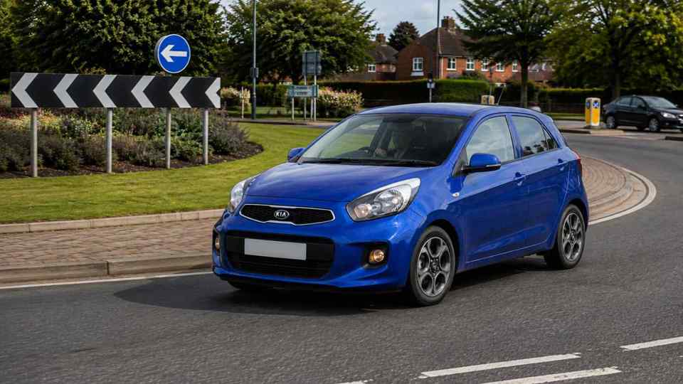 Blue Kia Picanto driving around a roundabout