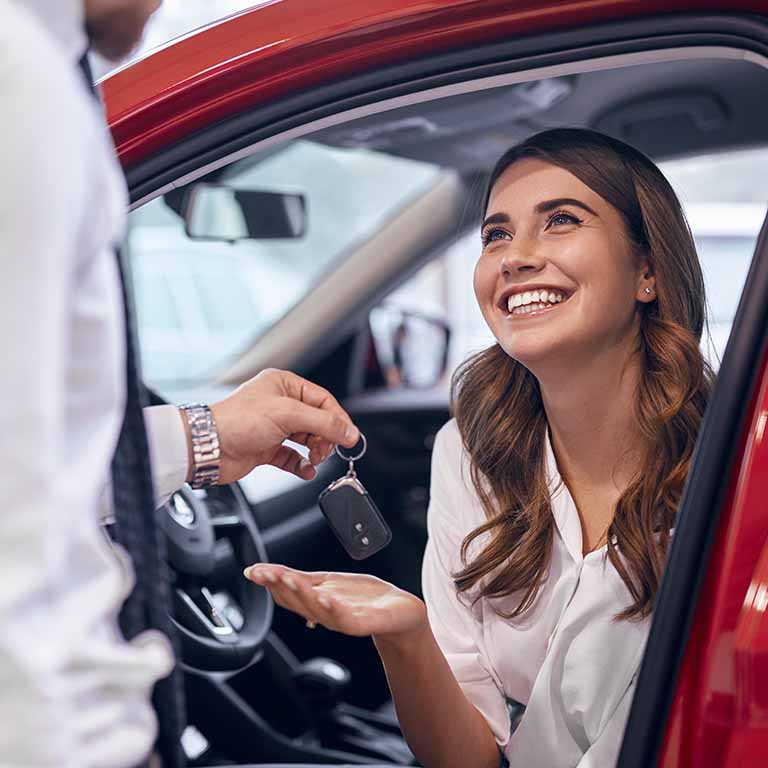Handing Keys To Happy Woman Red Car