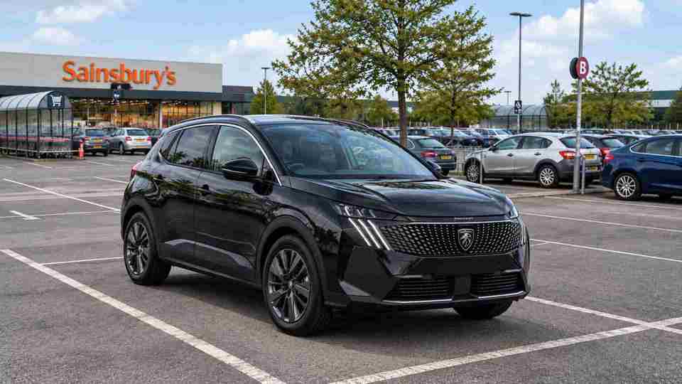 Black Peugeot 3008 parked outside of Sainsbury's