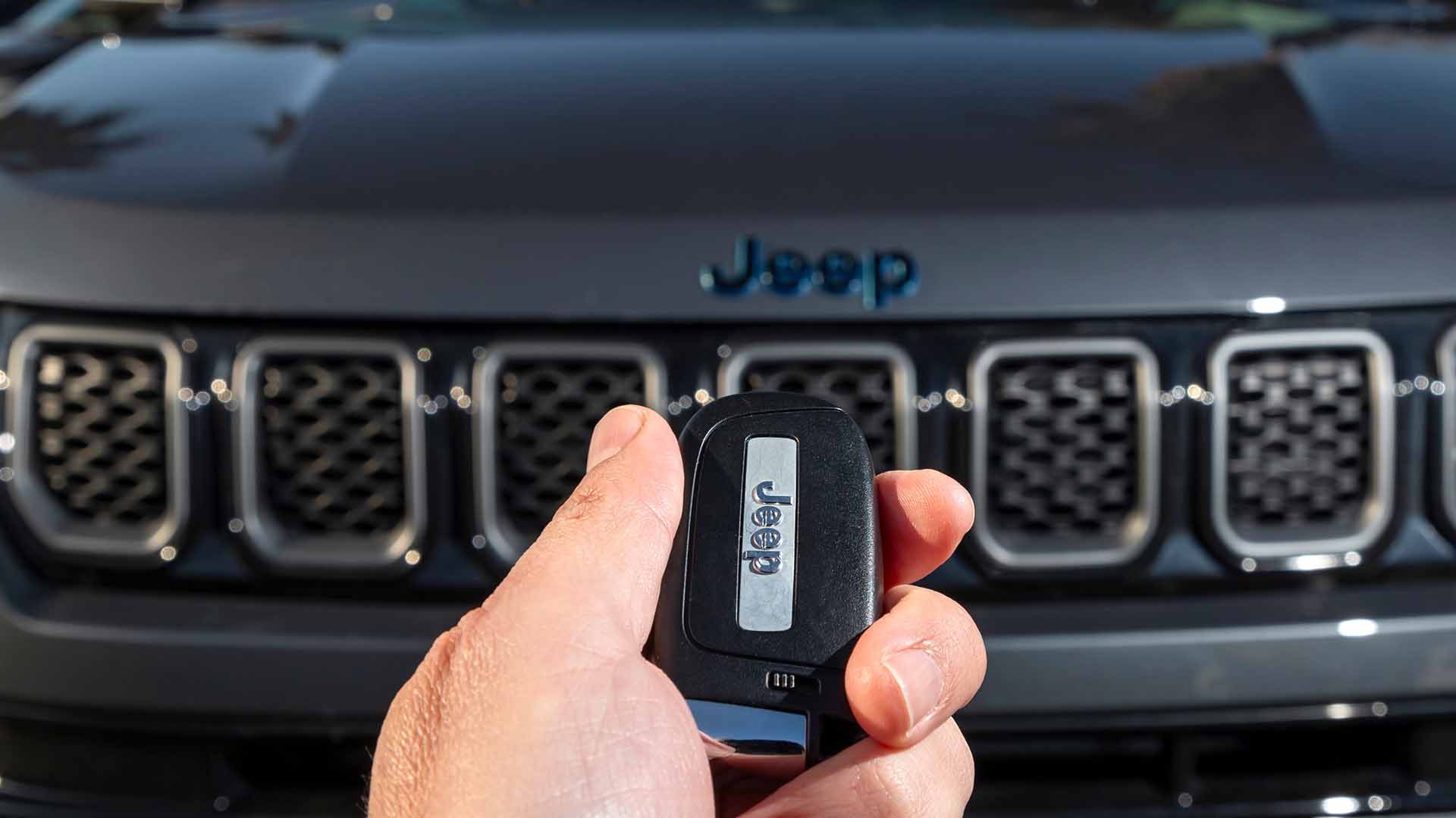 Hodling Jeep Keys Infront Of Bonnet